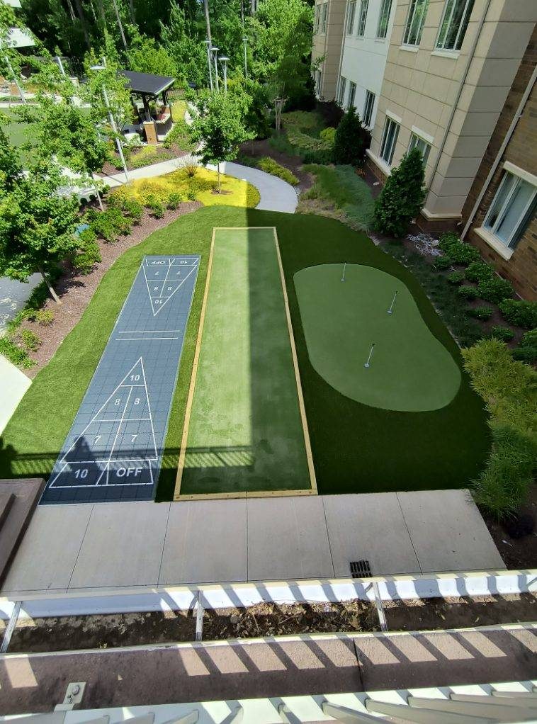 Luxury backyard putting green with stone surround NC