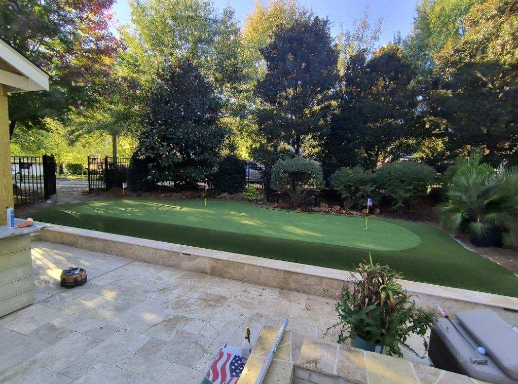 Backyard Tour Greens putting green with travertine patio NC