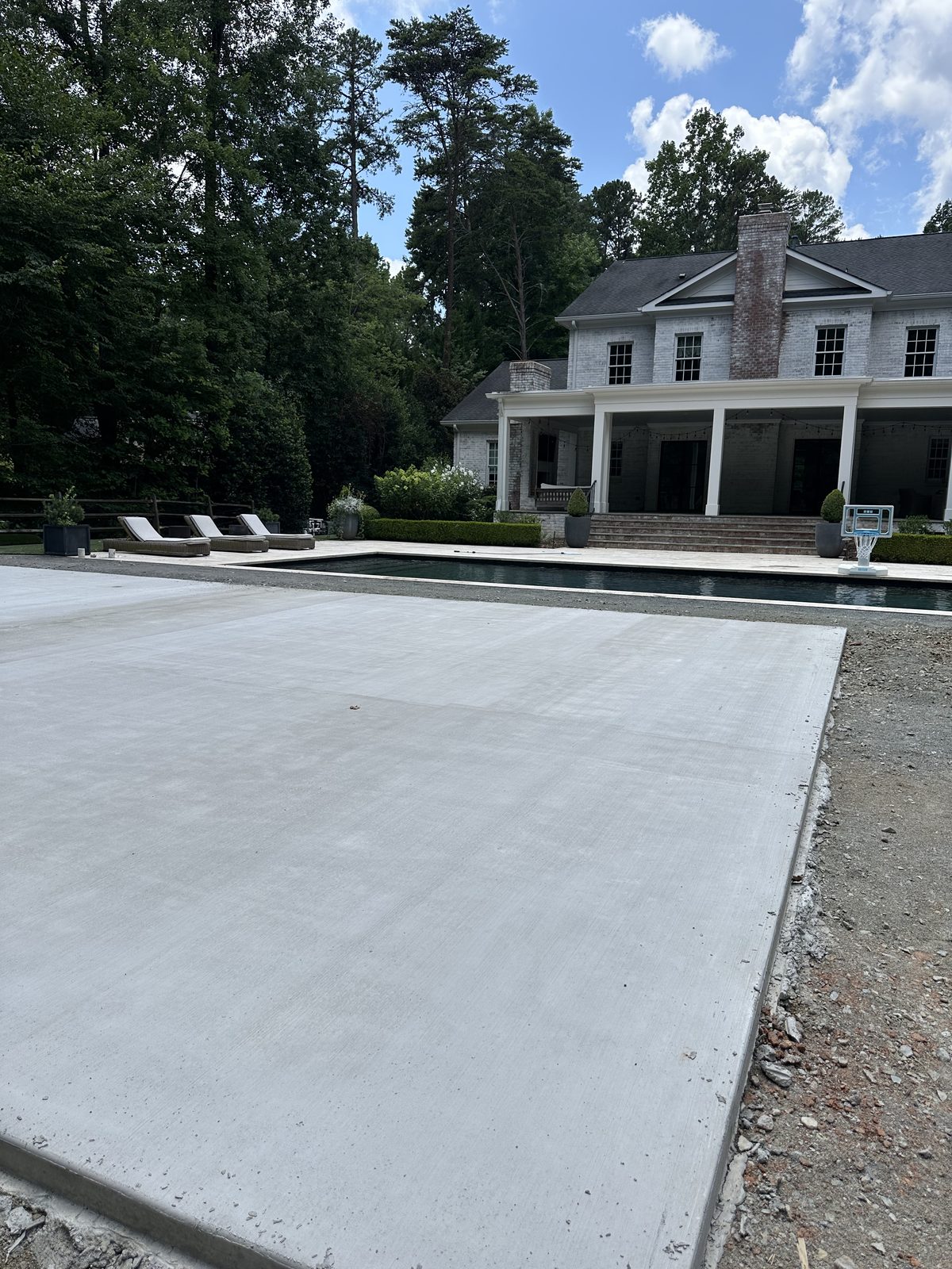 Poured concrete pad for backyard court